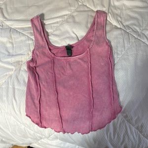 This is a light pink colored tank top with a ribbed, stretchy material.